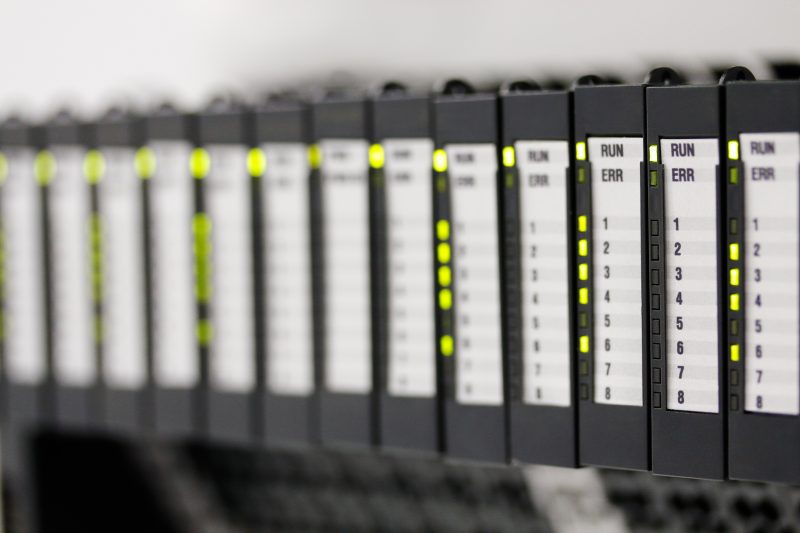 Programmable logic controllers installed in a control panel. Selective focus.